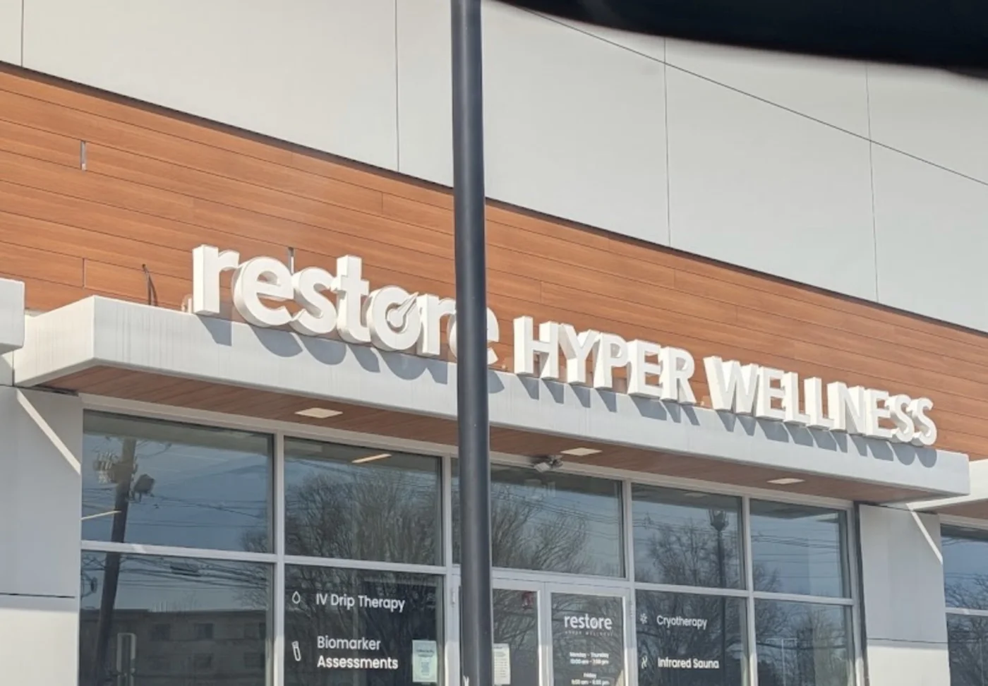Restore Hyper Wellness storefront with illuminated channel-letter signage in a retail centre
