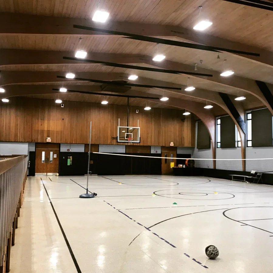 Barrel-vault gymnasium ceiling with newly installed recessed LED downlighting