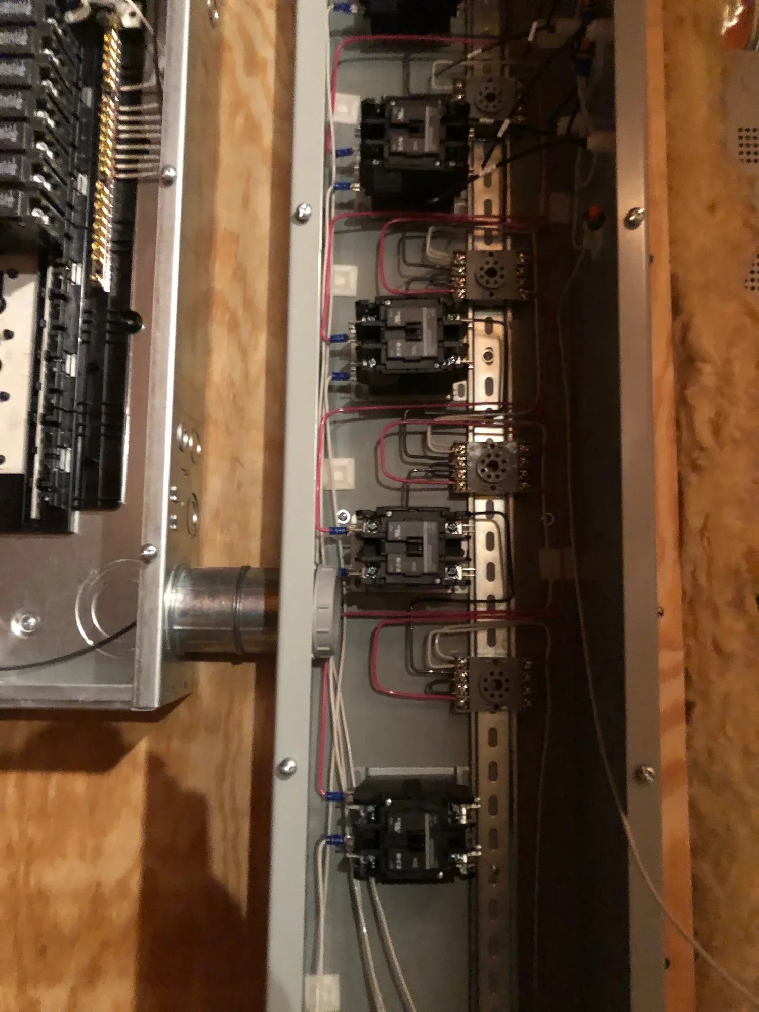 Open distribution equipment showing feeder breakers, terminations, and conductors
